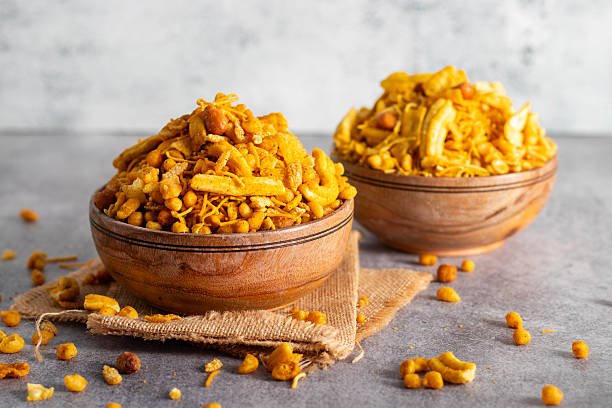 Bombay mix is a spicy, crunchy Indian snack blend of fried lentils, nuts, chickpea flour noodles, and aromatic spices.