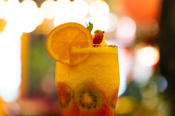 Cold sweet summer fruit juice cocktail glass.
